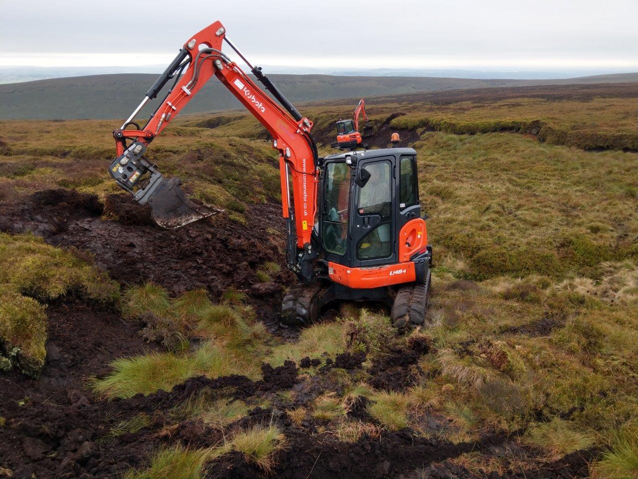 Excavators re-profiling gullies on Pendle Hill